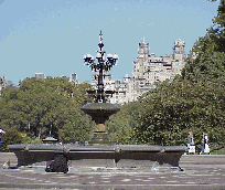 Center right is a picture of a fountain in Central Park with the city skyline in the distance.