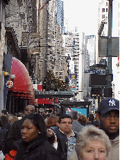 Top left you see a photo of the Empire State Building as seen on 33rd Street near Madison Square Garden. Top right photo you see the lunch time crowd near Macy's Department Store and West 34th Street.