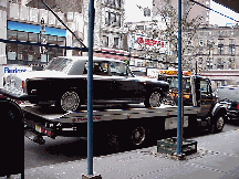 Center right you see one of the cars that will be unloaded and used for the movie.  Sometimes entire blocks are filled with period cars for movies.