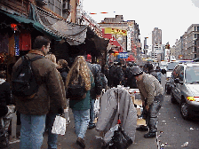 Bottom right picture you see a vendor selling his merchandise on the sidewalk of Canal Street.  It's probably illegal, but he's ready to run if the police come.