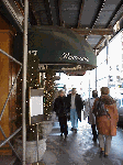 Center right, a restaurant and sidewalk of Mulberry Street.