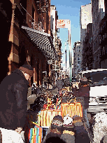 Top right picture you see shoppers enjoying  a selection of handbags and hats on a corner in Soho.