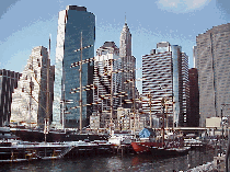 Bottom right you see the skyline of Manhattan and the ships that make up the South Street Seaport Museum as seen from a pier.