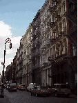 Center right you see a quiet and pretty street in SoHo lined with cast iron building's.