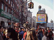 Bottom right picture you see Canal Street and the dragons in the distance.  A few of the streets are closed off for the parade as well as many of the Chinese businesses.  Canal Street is a major street and regular traffic goes through on an ordinary day.