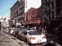 Center right you see many restaurants on Mulberry Street.  On nice days the waiters stand outside on the sidewalk welcoming  you to come in and dine.  The Italian accents combined with the smell of the food make lunch or dinner almost irresistible.