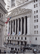 Center right picture is the New York Stock Exchange.  Nervous traders pace around in front of the building on breaks from their busy days of trading. Television reporters constantly report on the activity from the trading floors, while people mill about.