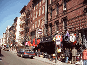 Top right and left pictures were taken on Orchard Street in the Lower East Side. Here you see the Jewish merchants selling coats and clothing.