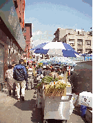 Top right photo you see a vendor selling vegetables and fruit in Chinatown.