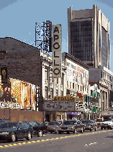 He's been the honored guest of many countries to share and demonstrate his art. He's standing in front of one of his famous paintings.    You'll find him every Sunday on 125th Street near the Apollo Theater. Top right picture is the Apollo Theatre.