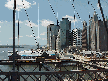 Bottom right picture you see a view of the southern tip of Manhattan as seen from the walkway on the Brooklyn Bridge.  You can see Pier 17 and South Street Seaport in the distance.