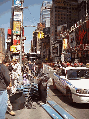 You can see the marquis for the play Annie Get Your Gun in the distance. Top right picture you see a man playing steel drums on Broadway.