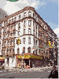 Center right you see a beautiful old building on Mulberry Street.  Sometimes you see the older Italian families sitting on the stoops chatting during lunch hour.