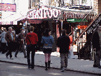 This is considered the East Village. Most of the time you will find young villagers hanging out under or around the cube. Bottom right picture you see a Tattoo shop in the East Village.