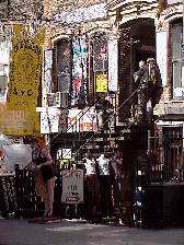 Top right picture you see cool villagers hanging out on the stairs of a shop on St. Mark's Place. St. Mark's Place is the 'main drag' for the stores and shops of the East Village.