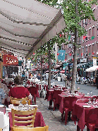 Center right picture you see everyone's favorite sport...eating!  You can go to Little Italy and have a great Italian lunch or dinner.  Get a seat outside if you can.  People watching is the number one sport of New York City.