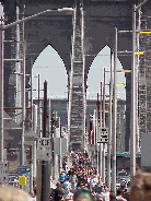 Top right picture you see heavy traffic as people walk across the Brooklyn Bridge on a nice day.