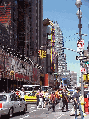 Top right picture you see the Jumbotron in Times Square on Broadway directly south of the Coke sign.  Here you can stand and watch the news on TV and be dazzled by the signs changing moment by moment.