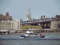 Center right photo you see a view of the Empire State Building from the Brooklyn Bridge as a police boat goes by.