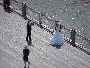 Top left photo you see a bride and groom on a pier in Brooklyn Heights posing for photos that will have the skyline of NYC in the background.