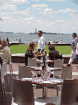 Top left photo you see people dining at Gigino Restaurant which is located on the most southern tip of the island at Battery Park.  That is the Statue of Liberty you see in the far distance.  What a view!