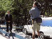 If you think it's easy for the newsmen, take a look at the photo top left.  The cameraman and newsman are standing on a thin police barricade to rise up high enough to show you on TV the scene at ground zero.