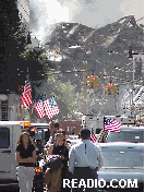 Center right picture you see ground zero as the ruins of the Twin Towers smolder and American flags wave in the smoke filled air.