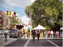 Bottom right picture you see Avenue A and Tompkins Square Park where a farmers market is taking place.  This area is known as the East Village.  The East Village is known for Off Off Broadway theater, shops, cool people and famous clubs like CBGB's.