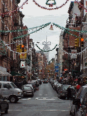 Top right picture you see the Christmas decorations on Mulberry Street.  In the far distance you see the Empire State Building.  If you look closely from the angle the picture was taken it looks like a bow on top of the Empire State Building.