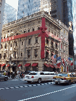 Top right picture you see a limousine making it's way past the Cartier Building on Fifth Avenue.  This time of the year buildings are wrapped for the holidays and chestnuts are roasting on every corner.  You'll even hear the sounds of silver bells!