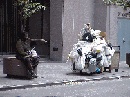 Center right you see a homeless man near Times Square.  Don't forget to help them out during the holidays and cold weather. Clean out your closets and give away your old coats. Homeless children need toys too. In NYC there are 12,000 homeless children.