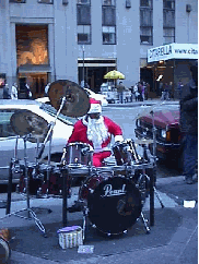 Okay, maybe the traditional Christmas songs and music leave you weepy... there's something for everyone in NYC.  Center right you see a rock n' roll Santa.  If you want to hear your favorite song, then remember the tip.