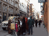 Bottom right picture you see a street vendor selling scarves and hats on the streets of Soho.  In nice weather the streets are lined with vendors.  Many artists that haven't made it to a gallery will sell their paintings on the sidewalks.