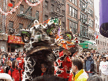 Bottom right picture you see a close up  of a pair of dragons as they bless a store on Mott Street. The action is fast and furious as the dragons dance in front of stores blessing the business as the drums pound out a loud beat.