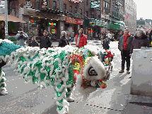 Center right picture you see another dragon that seemed to be left behind as the parade went down Mott Street. There is a character called the lion teaser that goes into the store and chases out the evil spirits before the dragons bless the establishment