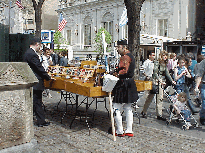 Center right photo you see a Jewish man selling books.  The man at the table is Greek.  The Greek man was a participant in the Greek Parade that had just passed by on Fifth Avenue.