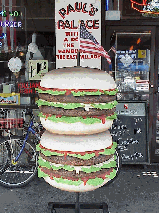 Center right picture you see a giant hamburger seen outside of Paul's Palace in the East Village.  It's a big day for the burgers and hotdogs.