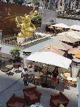 Top right picture you see the statue of Prometheus.  You also see the umbrellas and tables where people are enjoying a leisurely lunch. During the winter months this area becomes an ice skating rink.