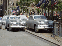 Center right photo you see a couple more antique automobiles being set up for the display.  You also see the flags of the United Nations.