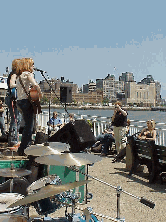 Center right picture you see Pier 40 which is one of the piers of the new Hudson River Park project.  You see musicians entertaining people on a hot summer day.  In the distance you see downtown NYC.