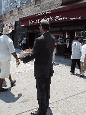 Center right picture you see 125th Street and one of Louis Farrakhan's followers with newspapers.