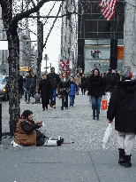 Older woman on Fifth Avenue begging for money