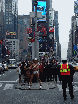 Naked Cowboy playing his guitar in the middle of Broadway