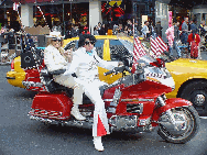 Elvis and a Biker Babe making their way down Broadway