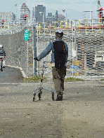 A man with his trike on the path along Stuyvesant Cove Park