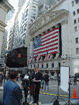 Wall Street as the press interviews in front of the New York Stock Exchange