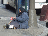 A poor lady begging on Fifth Avenue