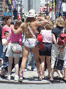 Naked Cowboy posing for pictures with tourists